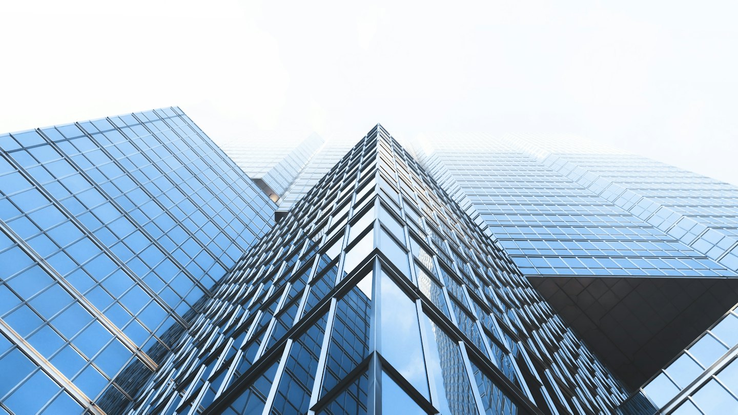 Modern glass office towers seen from below