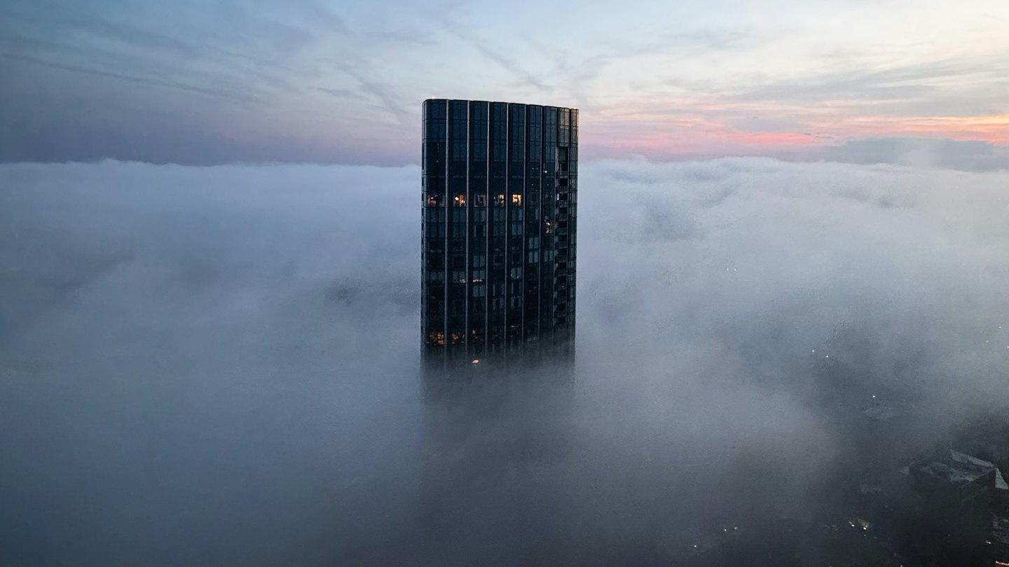 A tower rising above the morning fog