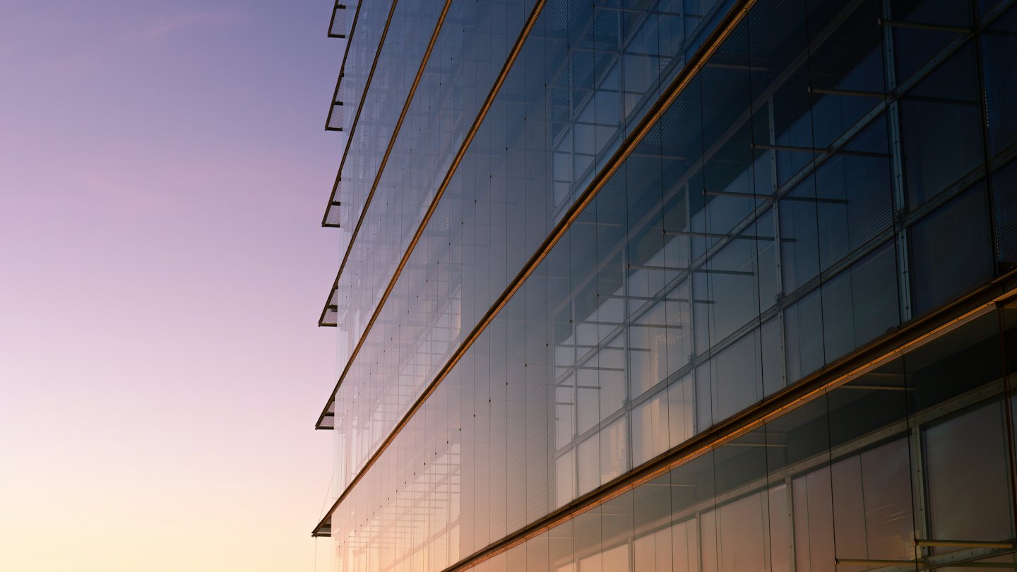 Glass office facade at dusk